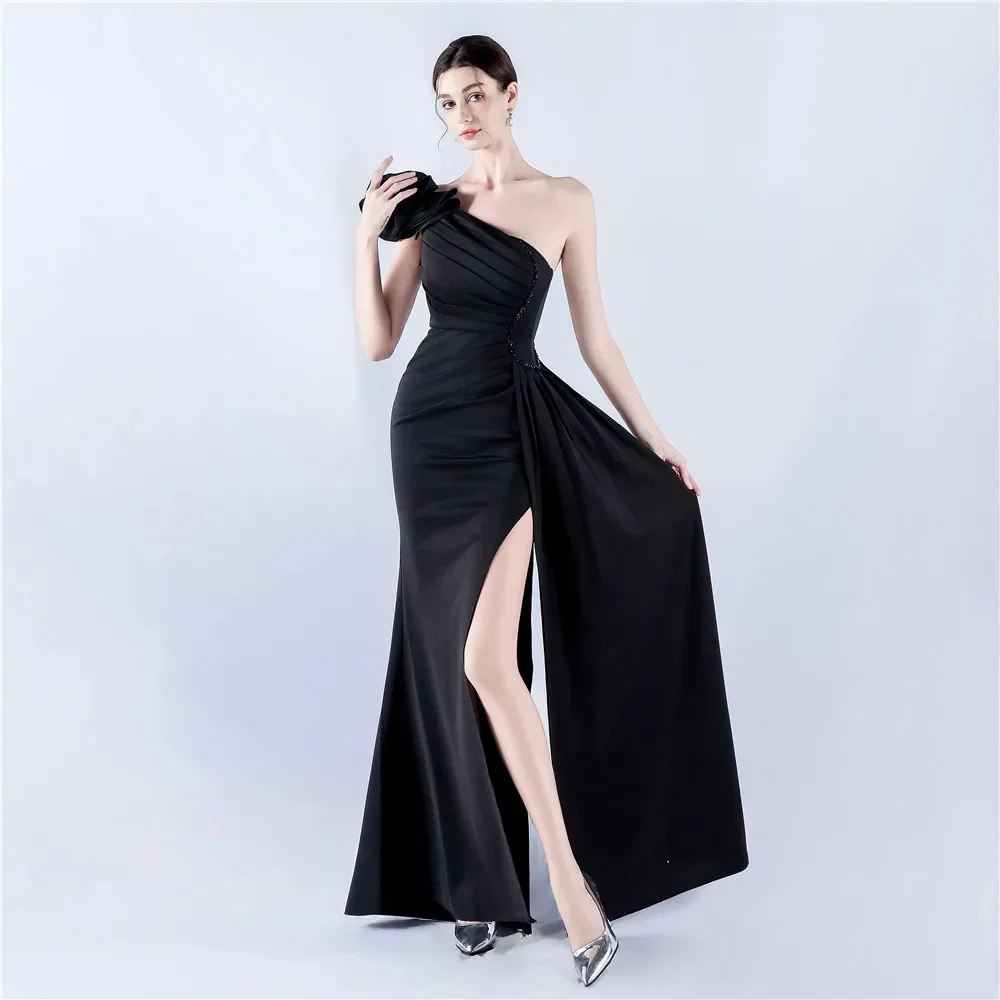 Customized black one-shoulder shaping floor-length evening gown. Fitted waist carves body curves, front slit brings smart charm.