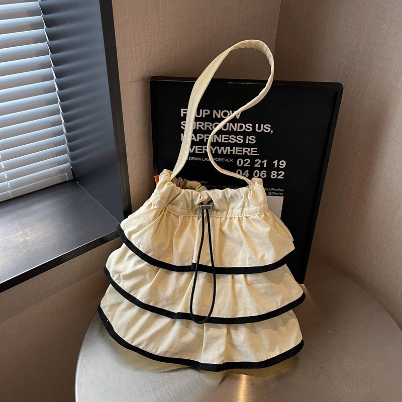 Versão coreana única moda cordão balde saco 2026 leve moda All-Match textura náilon pano bolsa de ombro TG68