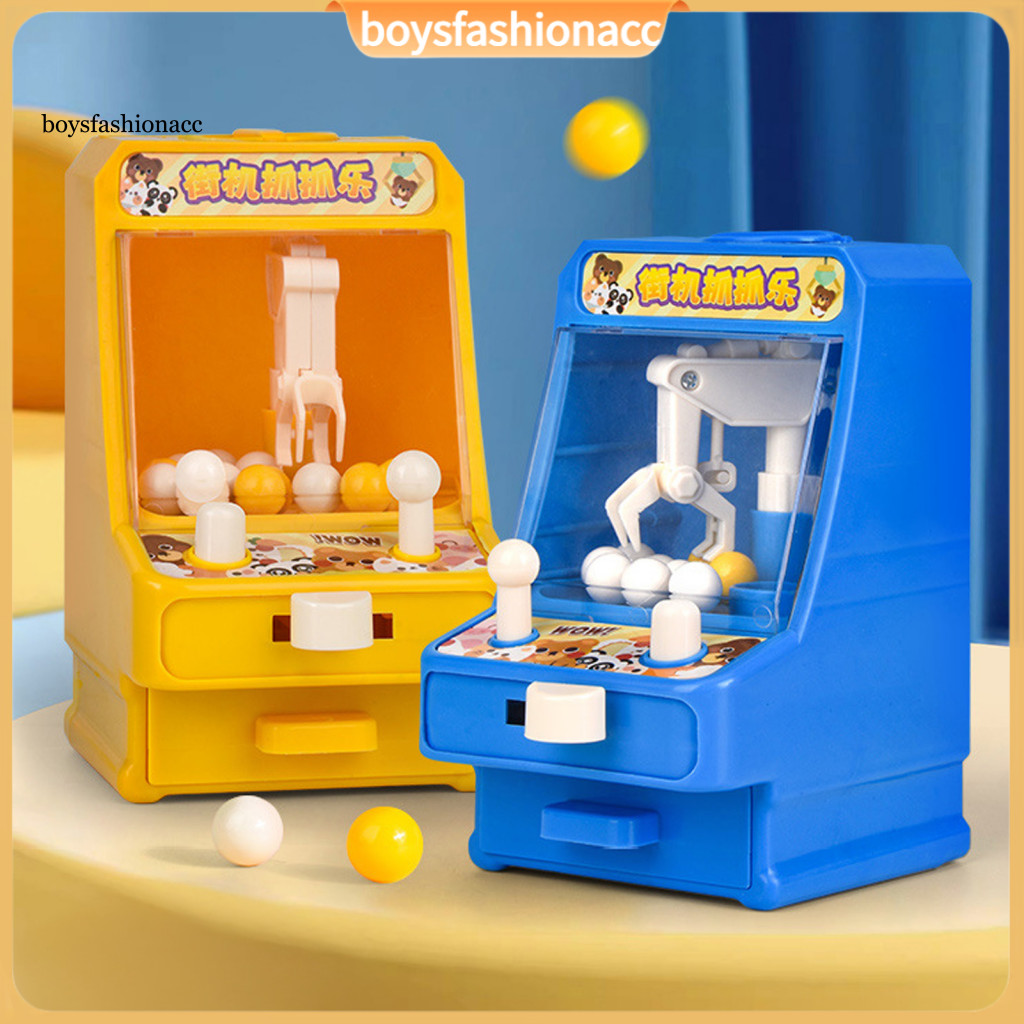 Mini children's claw machine controlled by rocker